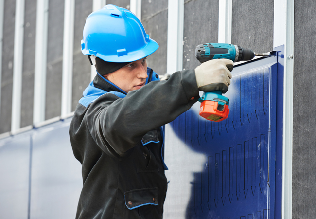 worker assembling facade metal construction